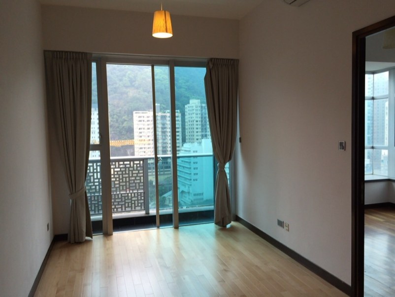 View of the living area on to the balcony.  The entrance to the bedroom is on the right. 